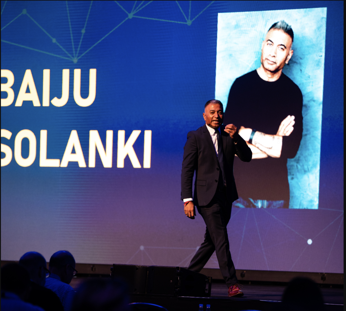 Baiju Solanki, Founder and CEO of EnSpirit Global, speaking on stage